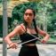 pexels-photo-2748245-2748245 A woman confidently posing with martial arts sai, showcasing beauty and strength, set against an outdoor background.